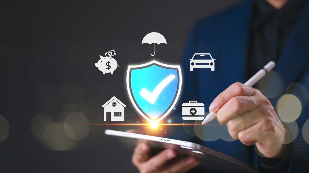 an image of a large checkmark on a shield, surrounded by icons for an umbrella, car, luggage, a home, and a piggy bank. it represents different kinds of insurance coverages